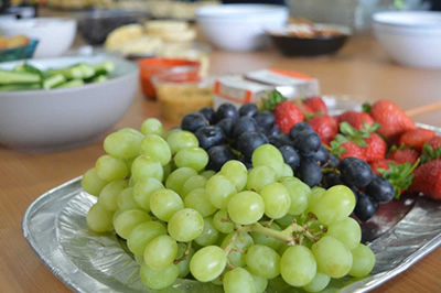 Photo of a plate with grapes, an blueberries on it.
